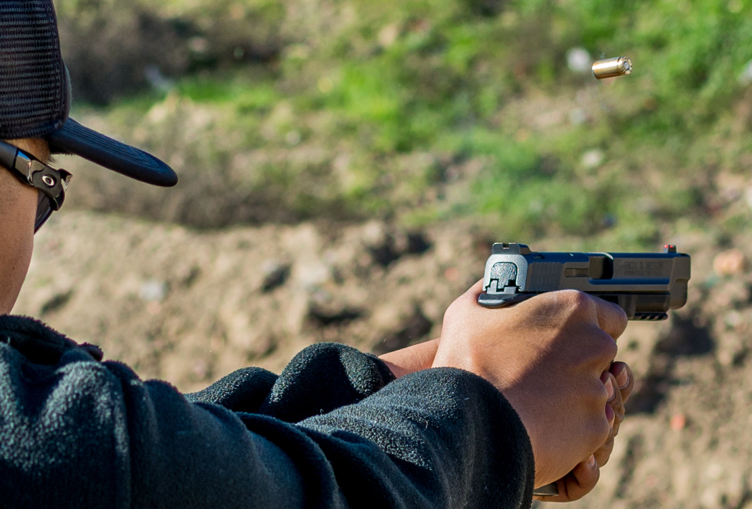 Example of shooting a handgun with iron sights during outdoor self defence shooting range practice.